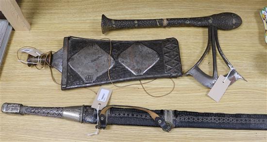 A Songye style ceremonial axe, the wooden handle covered in snakeskin, a Ngala style tribal knife and an Indian long sword,